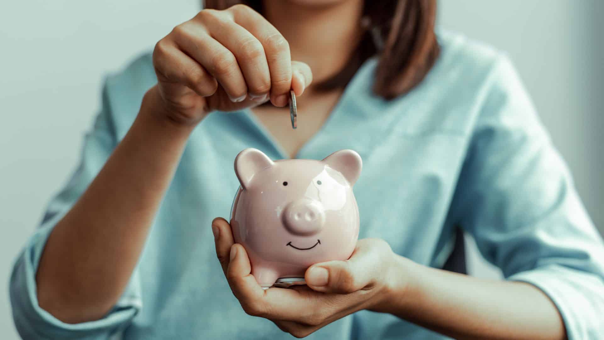Woman saving in a piggy bank