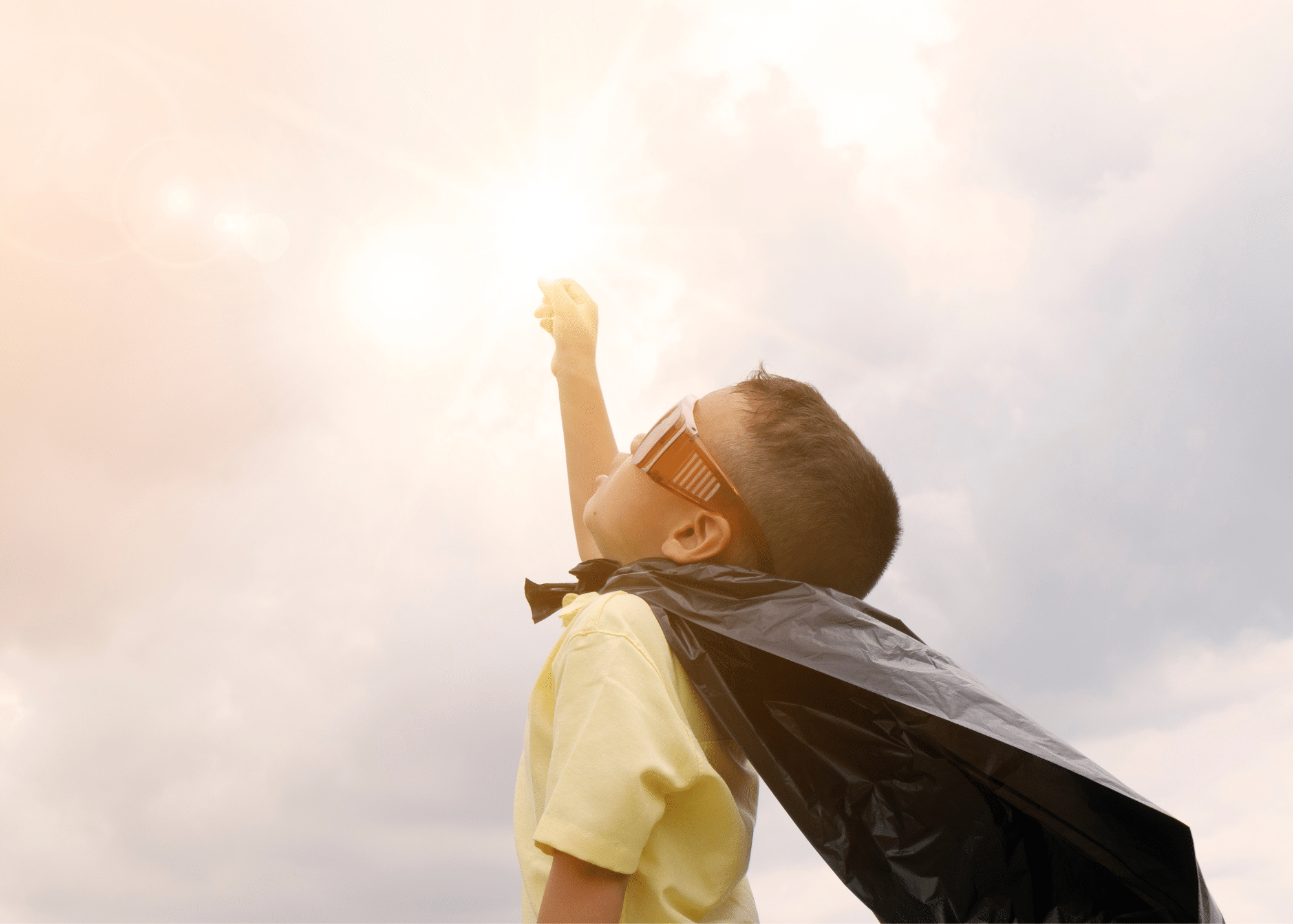 A child with cape looking into the sky