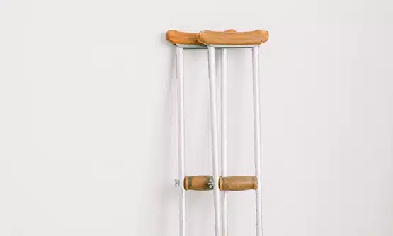 Pair of crutches leaning against the wall.